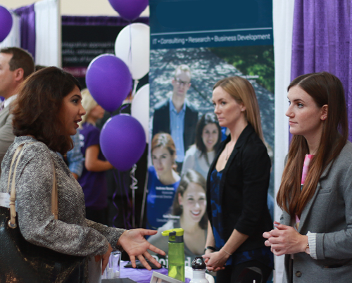An employer speaks with a student at a past Career Fair
