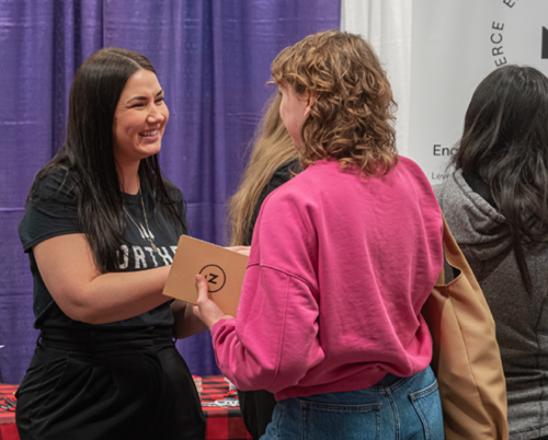 A student and employer networking at the hirewesternu Career Fair